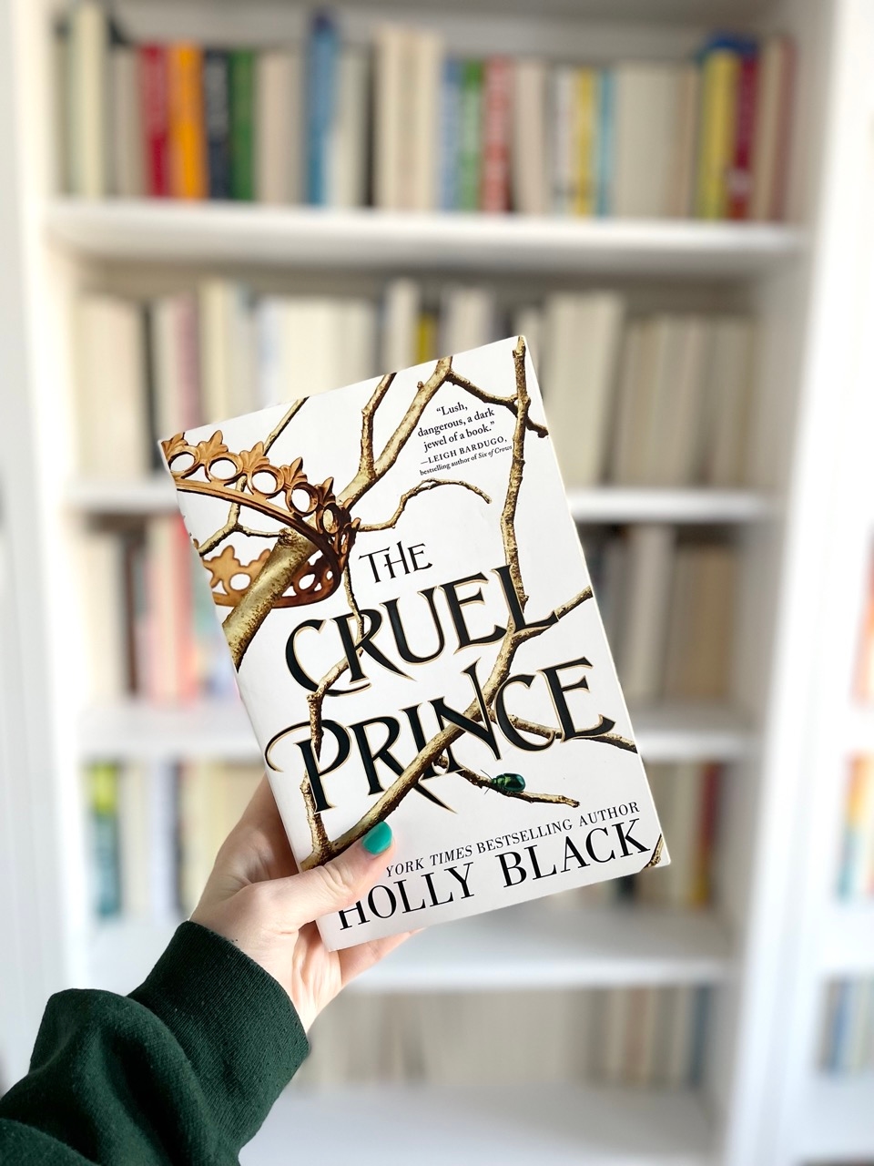 Front cover of the fantasy novel The Cruel Prince by Holly Black in front of a bookcase